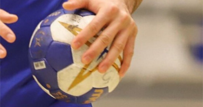 Në foto shihet dora e një hendbollisti duke e mbajtur topin.